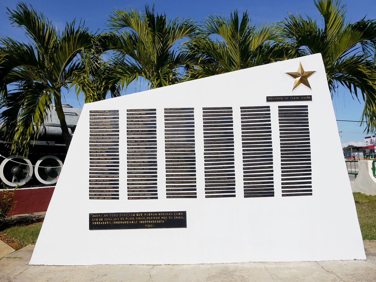 A large white memorial is covered in about 170 gold plaques with the names of Cuban soldiers who died in the Bay of Pigs invasion.