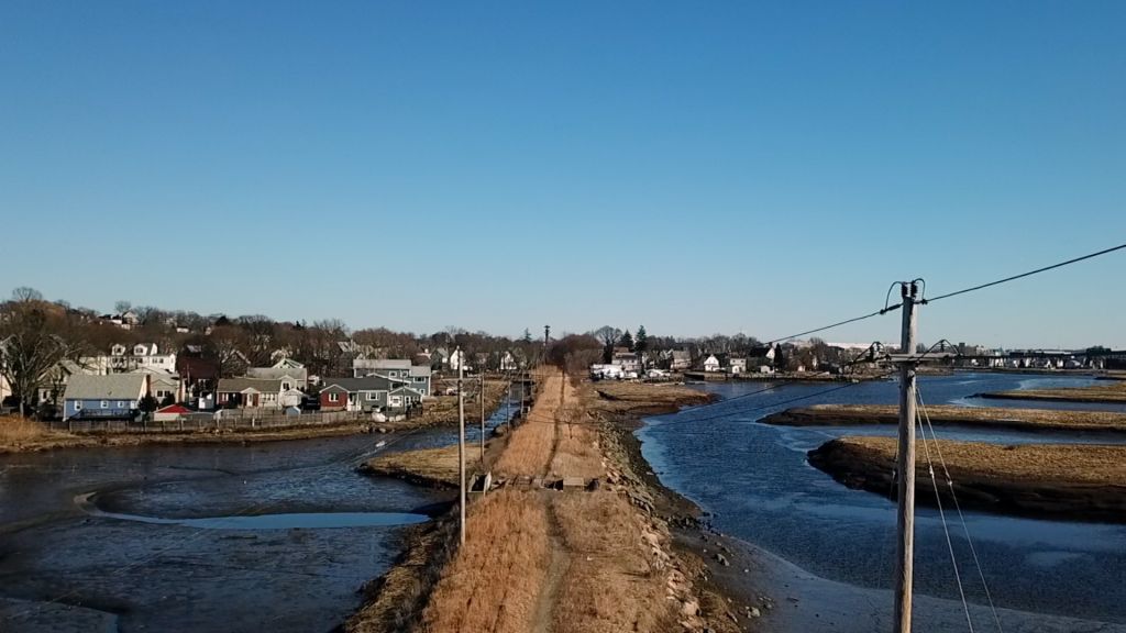 Aerial shot of bike path with water on each side.