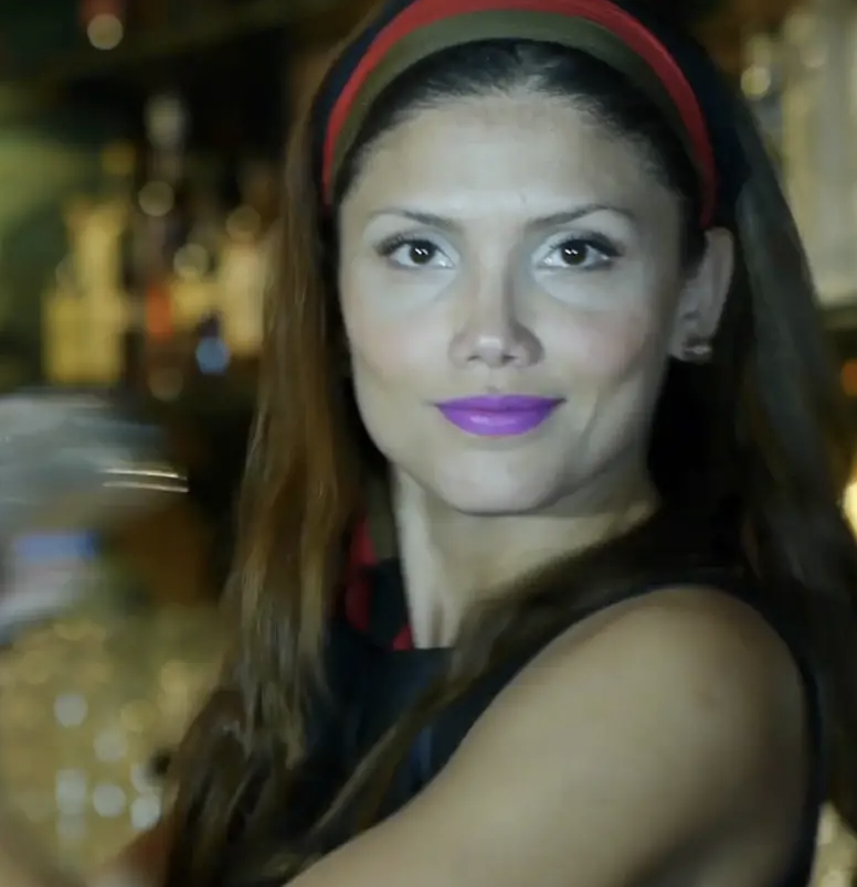 A woman with purple lipstick.
