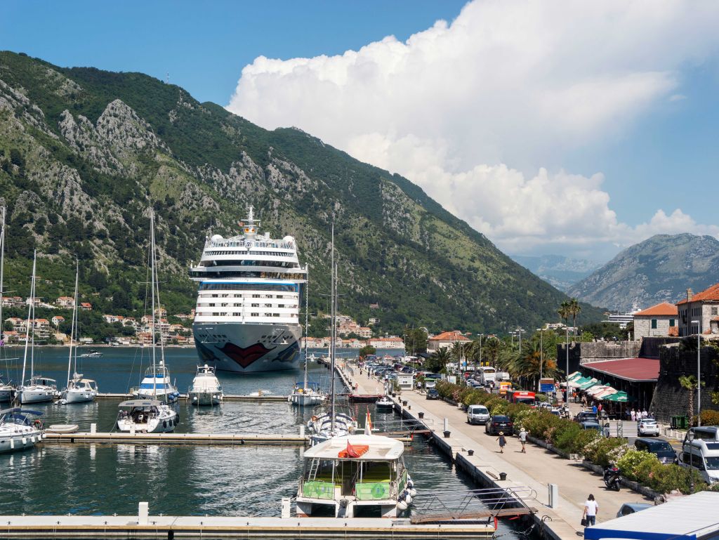 A huge cruise ship looms over the tiny harbor of Kotor in Croatia.